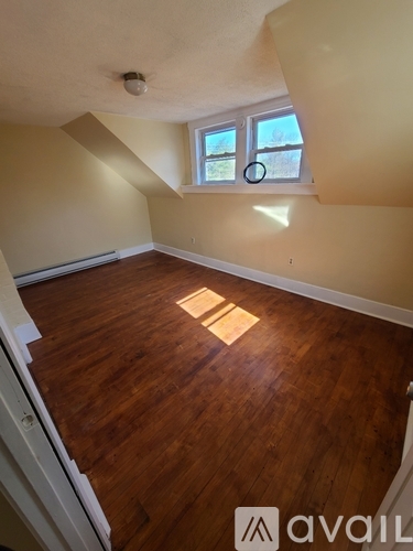 A room with wooden floors and a window.