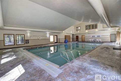 A large indoor swimming pool with a glass bottom.