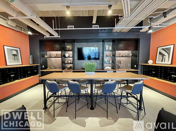 A conference room with a long table surrounded by chairs.