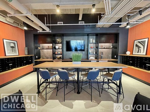 A conference room with a long table surrounded by chairs.