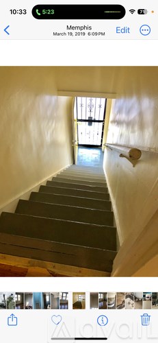 A staircase leading to a door with sunlight coming through the window.