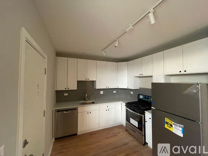A kitchen with white cabinets and a black stove top oven.