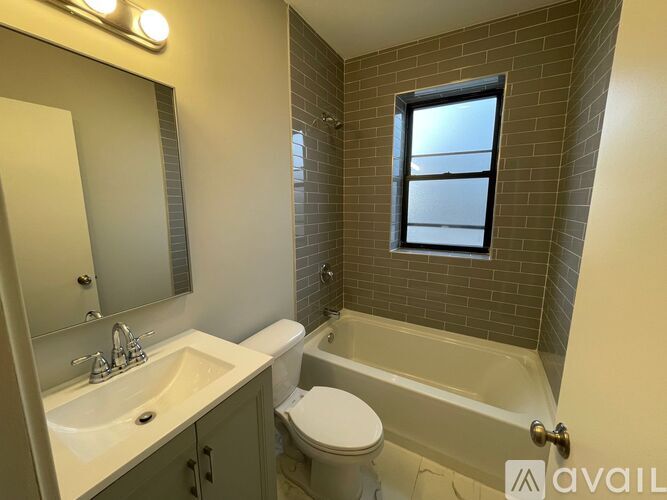 A bathroom with a white sink, toilet, and bathtub.