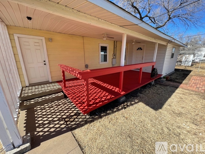 A red porch railing on a house.