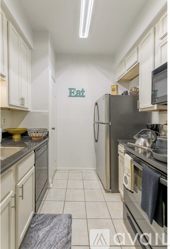 A kitchen with a refrigerator and a sign that says "Eat".