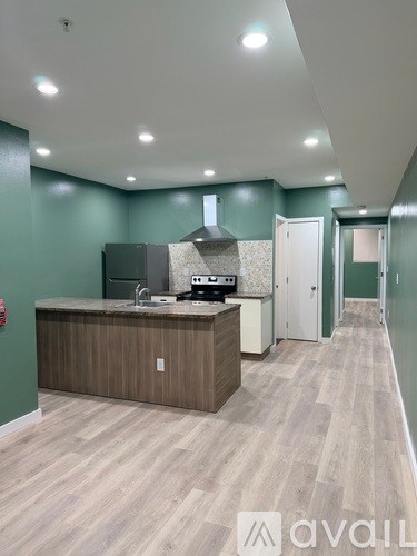 A kitchen area with a counter and cabinets.