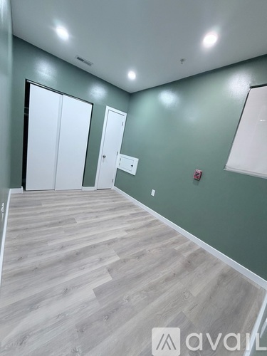 A room with wooden flooring and white doors.