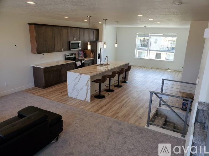 A kitchen with a table and chairs in the middle of the room.