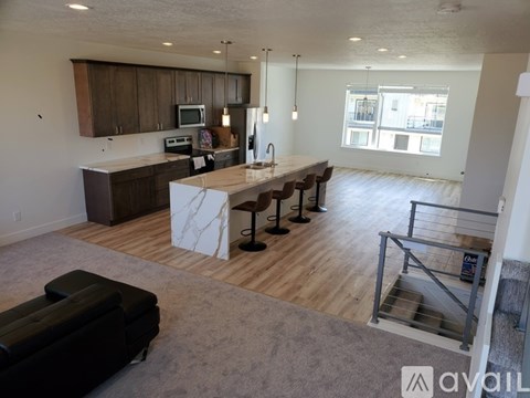 A kitchen with a table and chairs in the middle of the room.