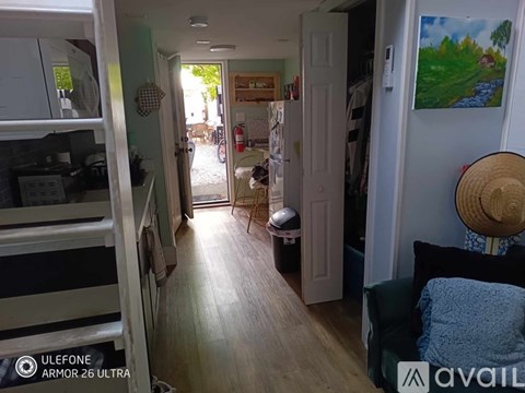 A hallway with a doorway leading to a balcony.