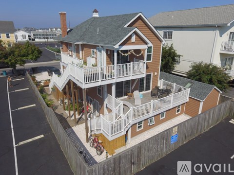 A two-story house with a balcony and a bicycle parked in front.