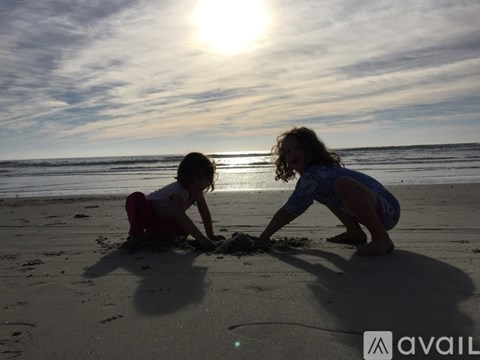 Two people playing in the sand at the beach.
