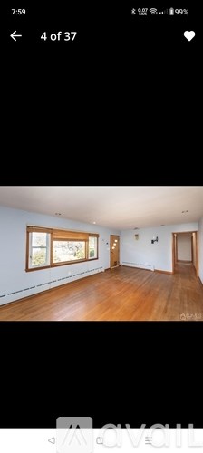A room with wooden floors and white walls.