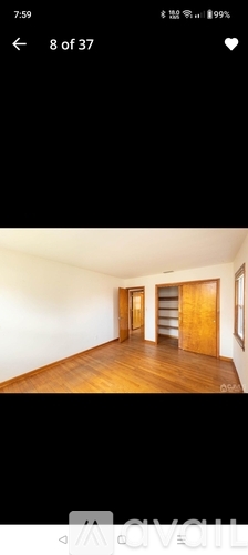 A room with wooden floors and white walls.