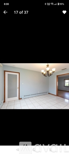 A room with a chandelier and a door is shown.