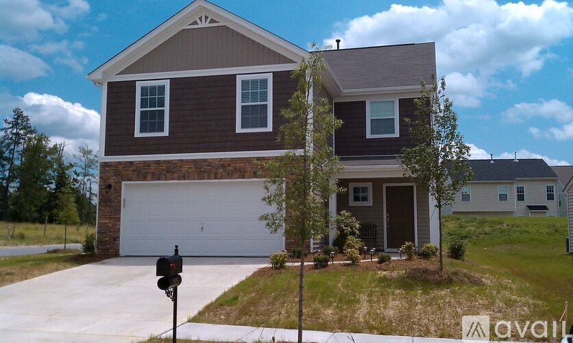 A house with a brown and white exterior is for sale.