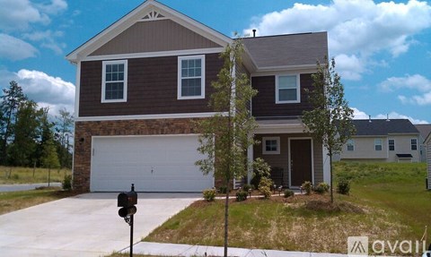 A house with a brown and white exterior is for sale.