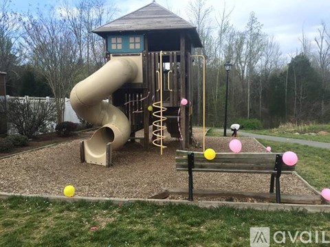 A playground with a yellow ball on the ground.