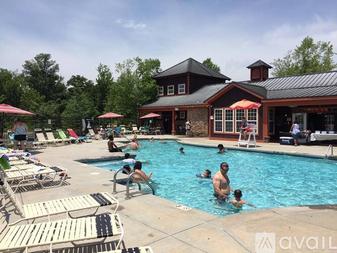 A group of people are enjoying a sunny day at the pool.