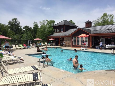 A group of people are enjoying a sunny day at the pool.