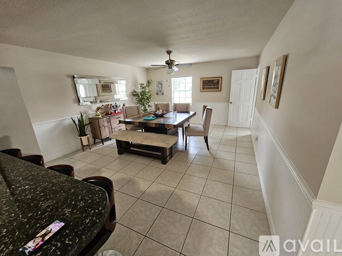 A living room with a dining table and chairs.