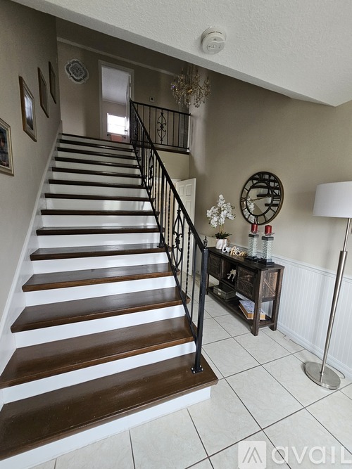 A staircase with a black railing and wooden steps.
