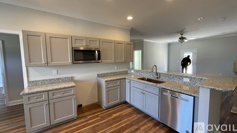 A kitchen with wooden cabinets and granite countertops.