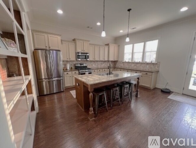 A kitchen with wooden floors and a large island in the middle.