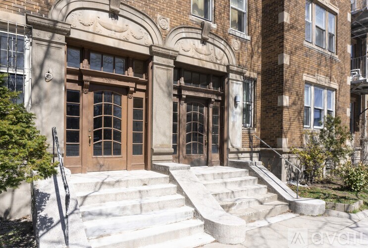 A large brown door with a glass panel is the main focus of this image.