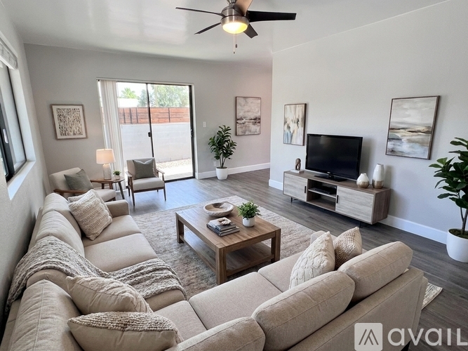 A living room with a large sectional sofa and a coffee table.