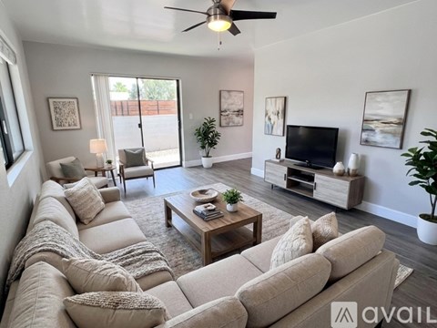 A living room with a large sectional sofa and a coffee table.