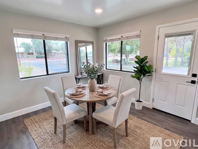A dining room with a round table and chairs.