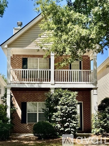 A house with a white porch and a brick chimney.