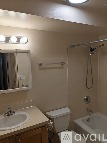 A bathroom with a sink, toilet, and bathtub.