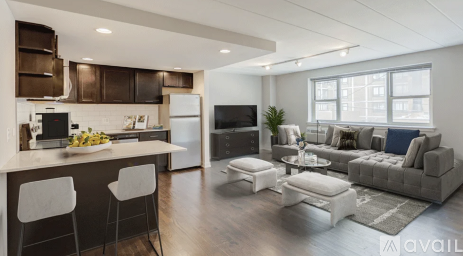 A modern kitchen with white appliances and a bar area.