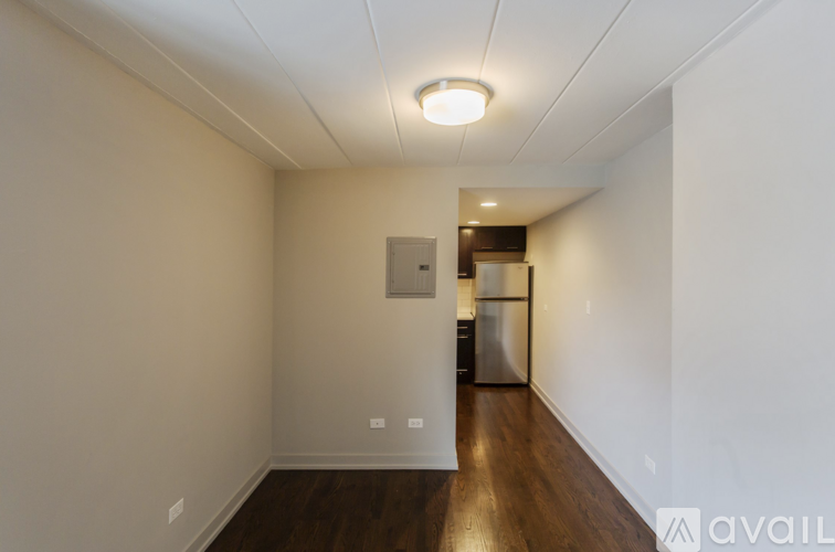 A room with a white ceiling and a wooden floor.