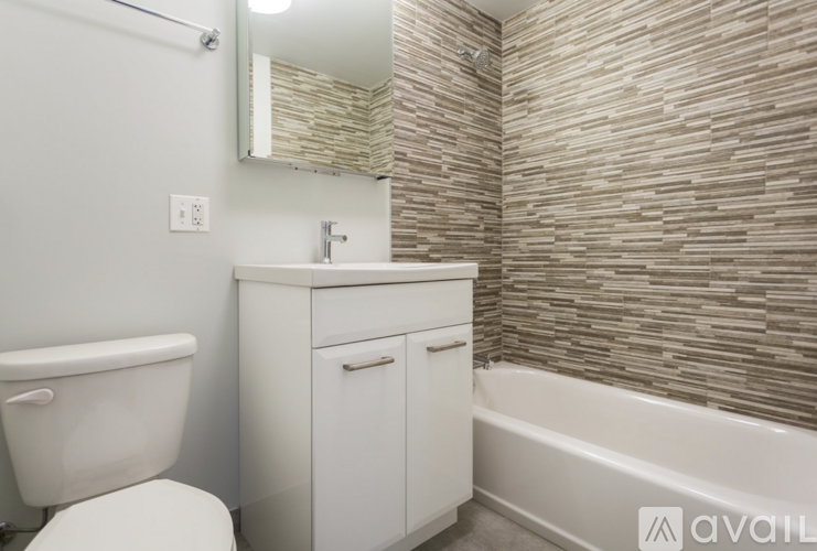 A bathroom with a white toilet, sink, and bathtub.