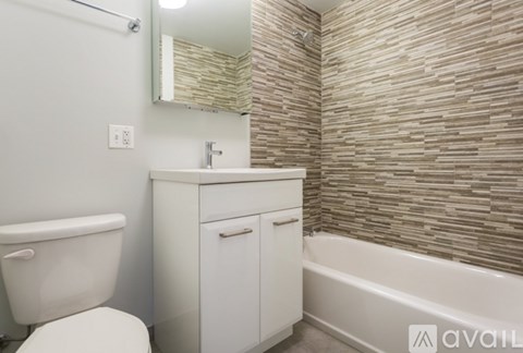 A bathroom with a white toilet, sink, and bathtub.