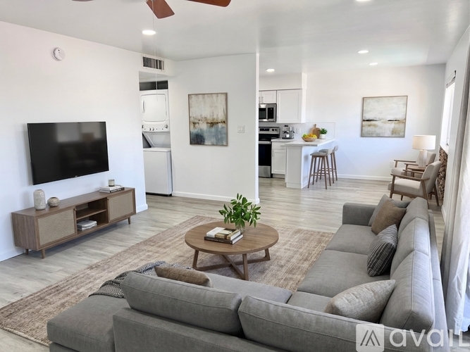 A living room with a grey couch and a wooden coffee table.
