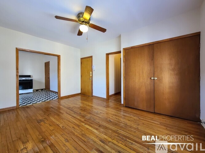 A room with wooden floors and a ceiling fan.