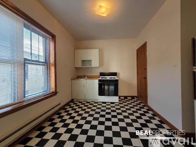 A black and white checkered floor in a room with a window.