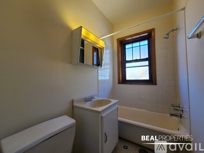 A bathroom with a toilet, sink, and bathtub.