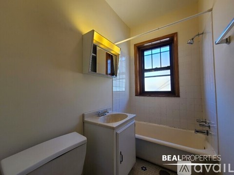 A bathroom with a toilet, sink, and bathtub.