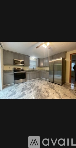 A kitchen with a stove, microwave, and oven.