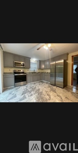 A kitchen with a stove, microwave, and oven.