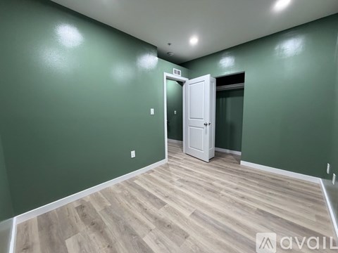 A room with green walls and a white door.