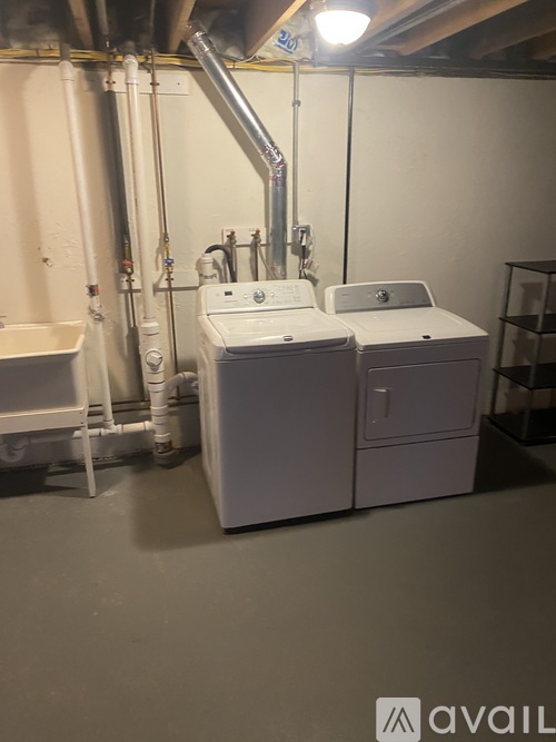 A room with a washing machine and a dryer.