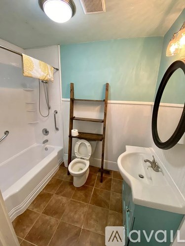 A bathroom with a toilet, sink, and bathtub.