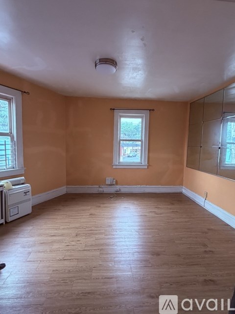 A room with wooden floors and a window.