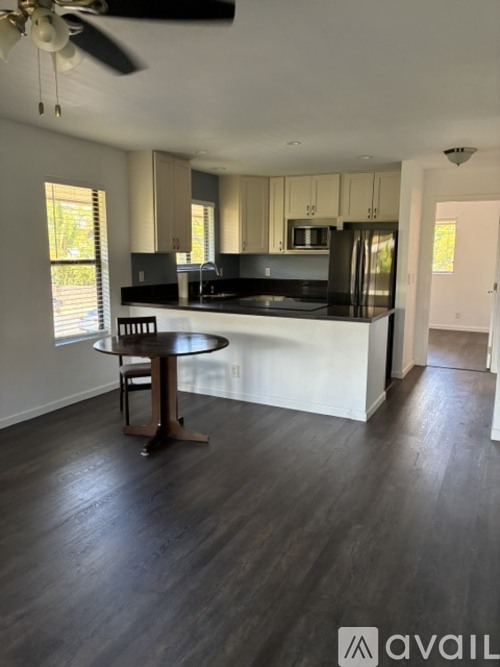 A kitchen with a table and chairs in the middle of the room.